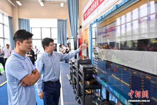 圖為蘇炳添在訓練基地內了解數字化跑道分析系統。中新社記者 陳驥旻 攝